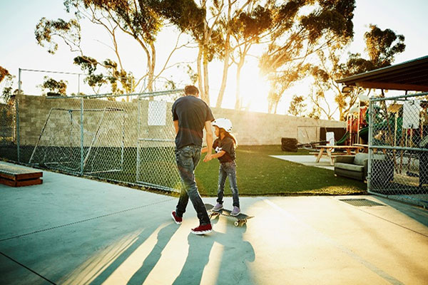 un parent et son enfant sur un skateboard