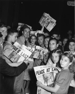 A group of people holding newspapers