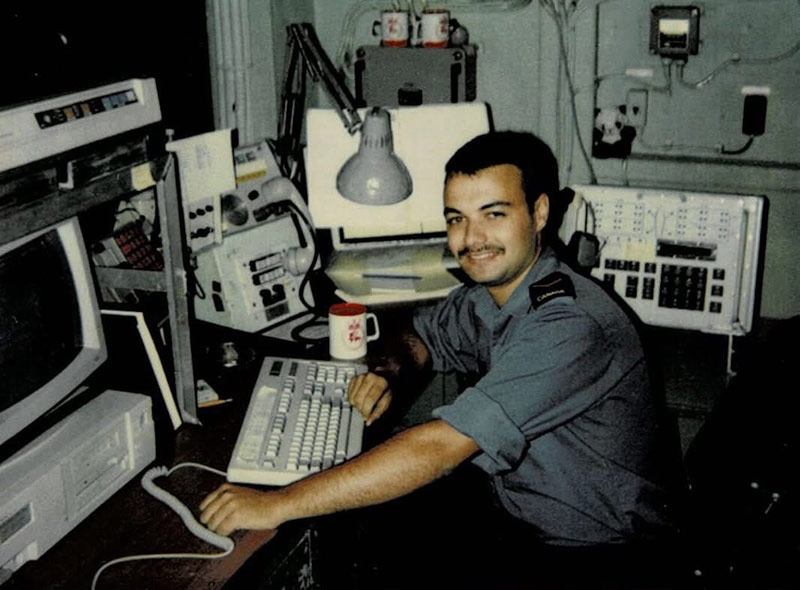 Gerald Doutre sitting at a desk with a computer. 